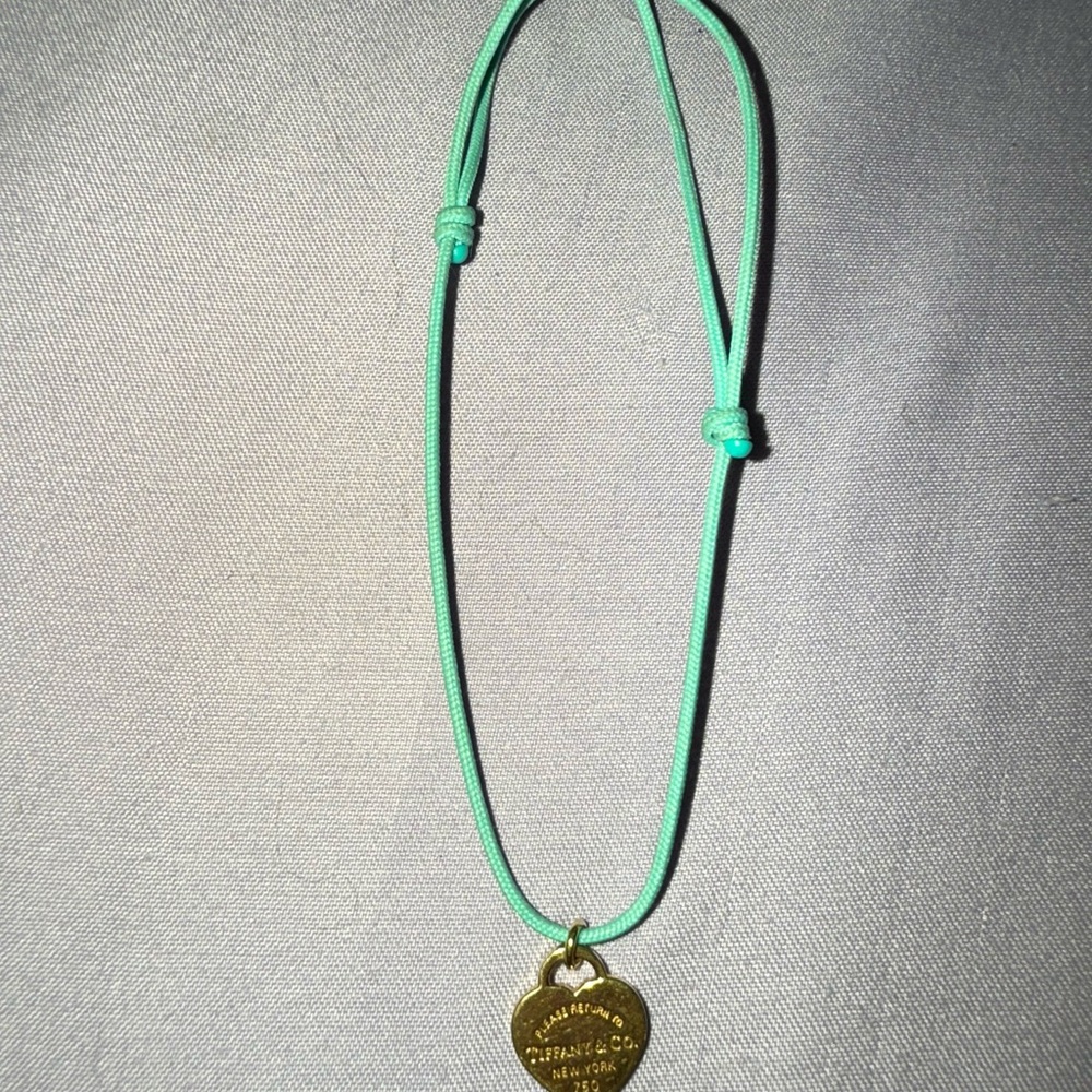 Tiffany and Co 18 K Gold Pendant on Turquoise Cord bracelet